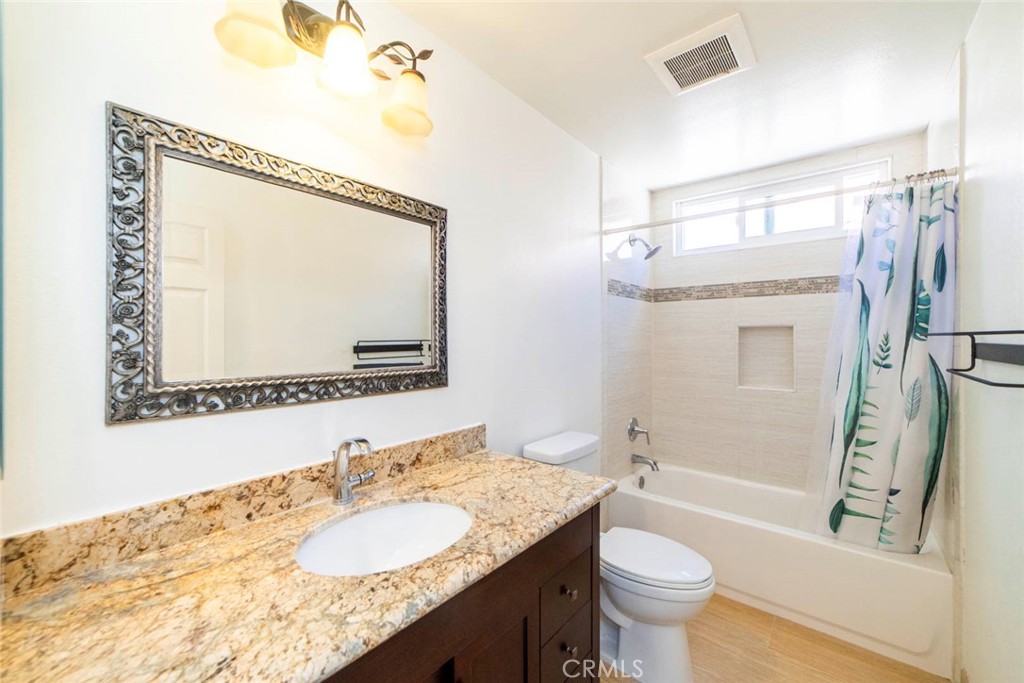 1 Camden Irvine, CA 92620 - Photo 22 of 43 a bathroom with a granite countertop sink toilet and shower