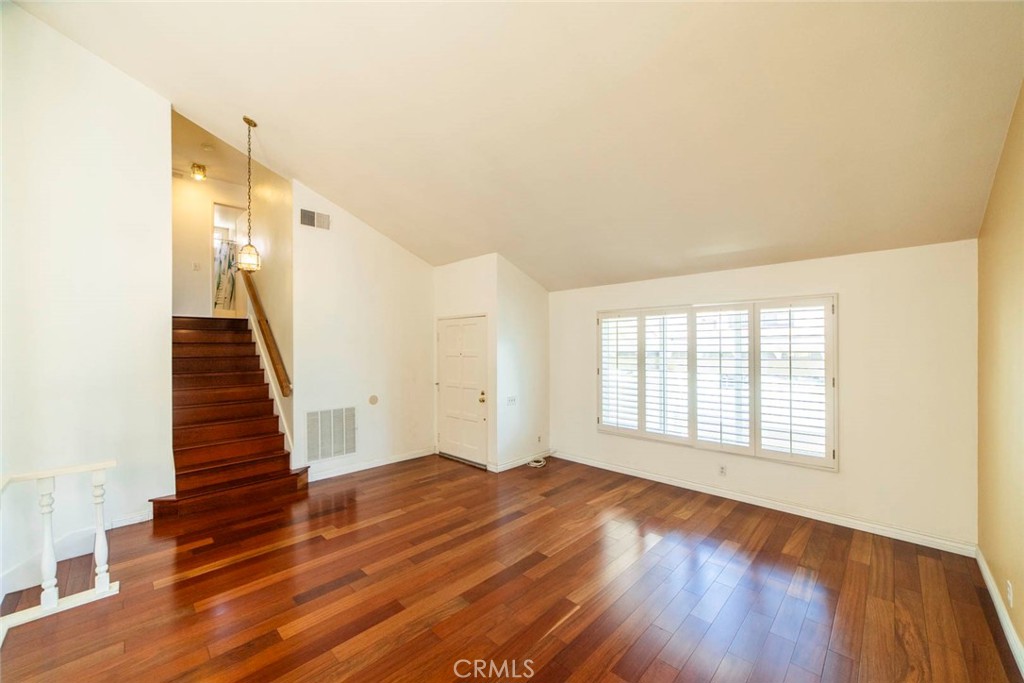 1 Camden Irvine, CA 92620 - Photo 3 of 43 a view of an empty room with wooden floor and stairs
