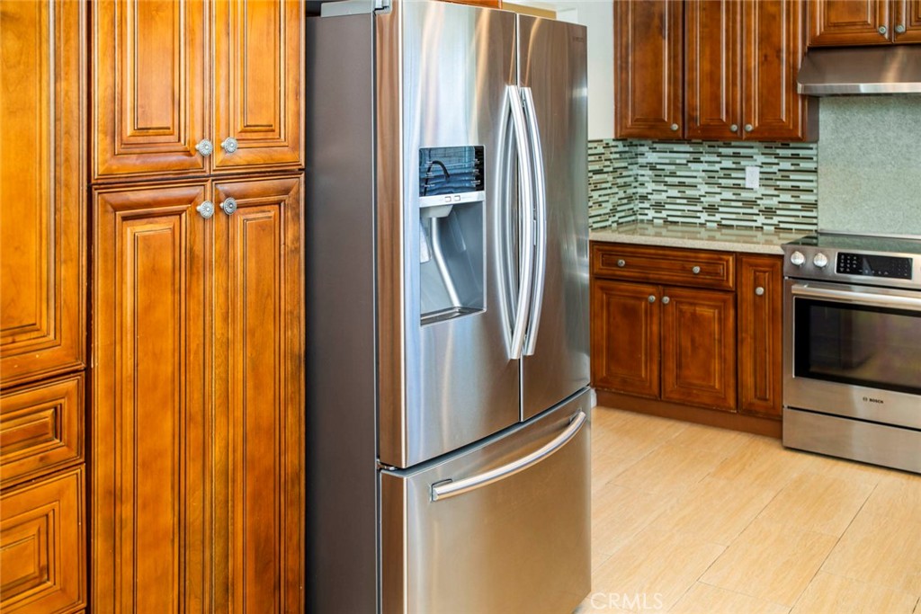 1 Camden Irvine, CA 92620 - Photo 40 of 43 a kitchen with stainless steel appliances granite countertop a refrigerator and a stove top oven