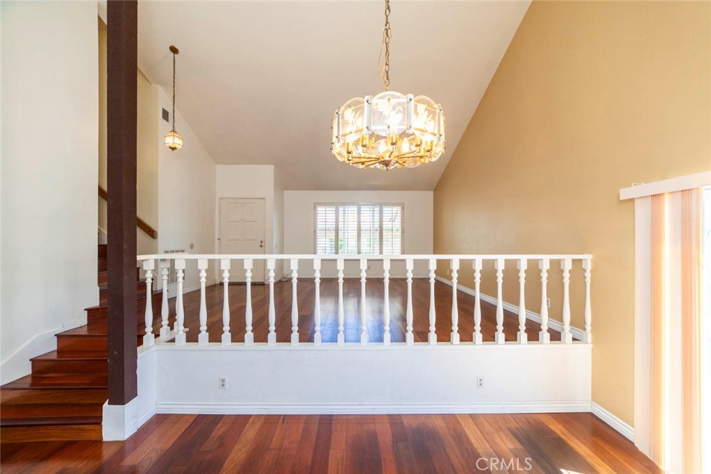 1 Camden Irvine, CA 92620 - Photo 5 of 43 a view of a hallway with wooden floor and a chandelier