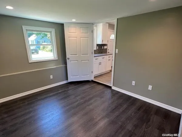 wooden floor in an empty room and a window