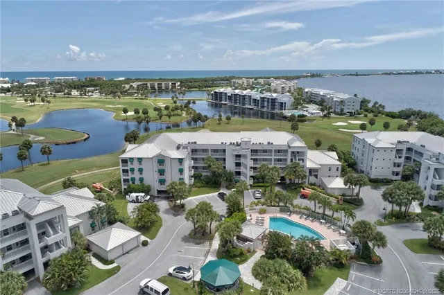 an aerial view of a house with a swimming pool outdoor seating and yard