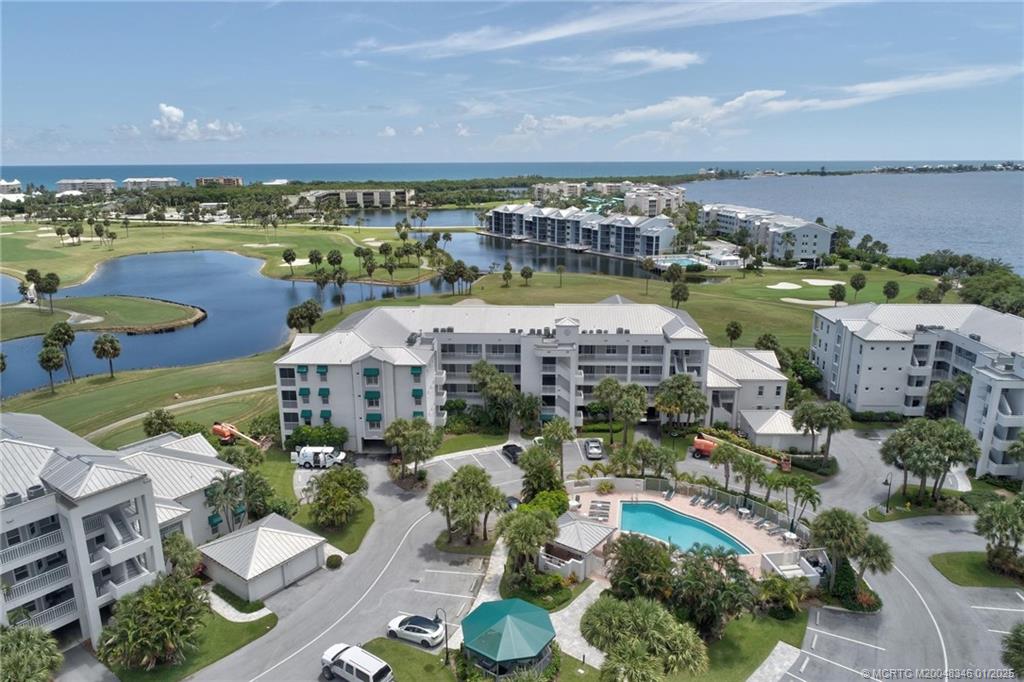 an aerial view of a house with a swimming pool outdoor seating and yard