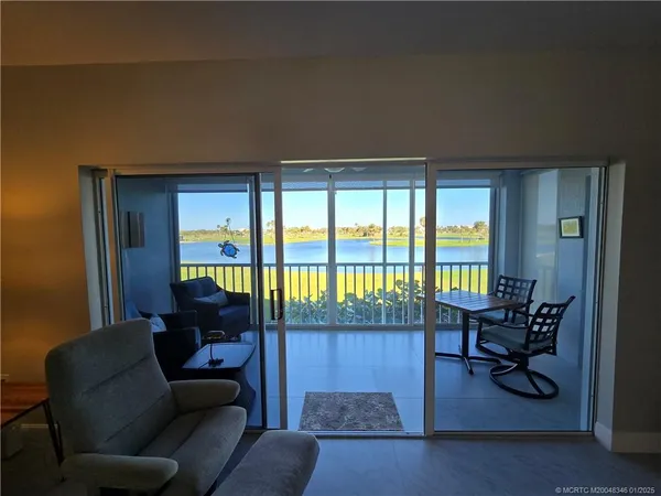 a view of a swimming pool and ocean from a balcony