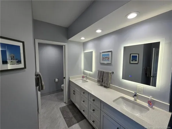 a bathroom with a double vanity sink a mirror and a