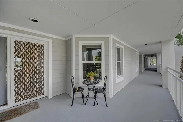 a white kitchen with a refrigerator a stove top oven a sink and cabinets