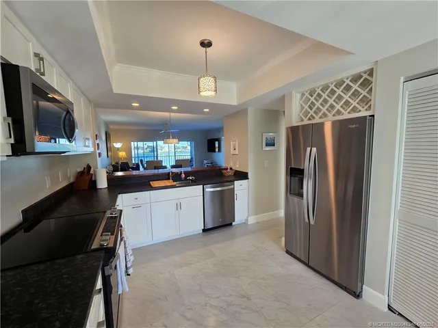 a view of a room with furniture and a window
