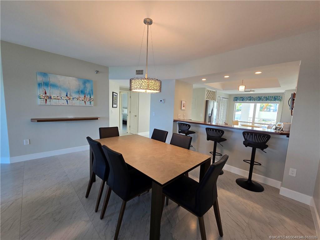 185 Northeast Edgewater Drive, Unit 5105 Stuart, FL 34996 - Photo 7 of 28 a view of a dining room with furniture
