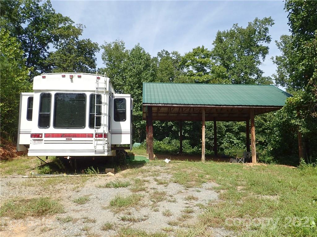 2915 Big Level Road Mill Spring, NC 28756 - Photo 9 of 26 a view of house with yard and sitting area