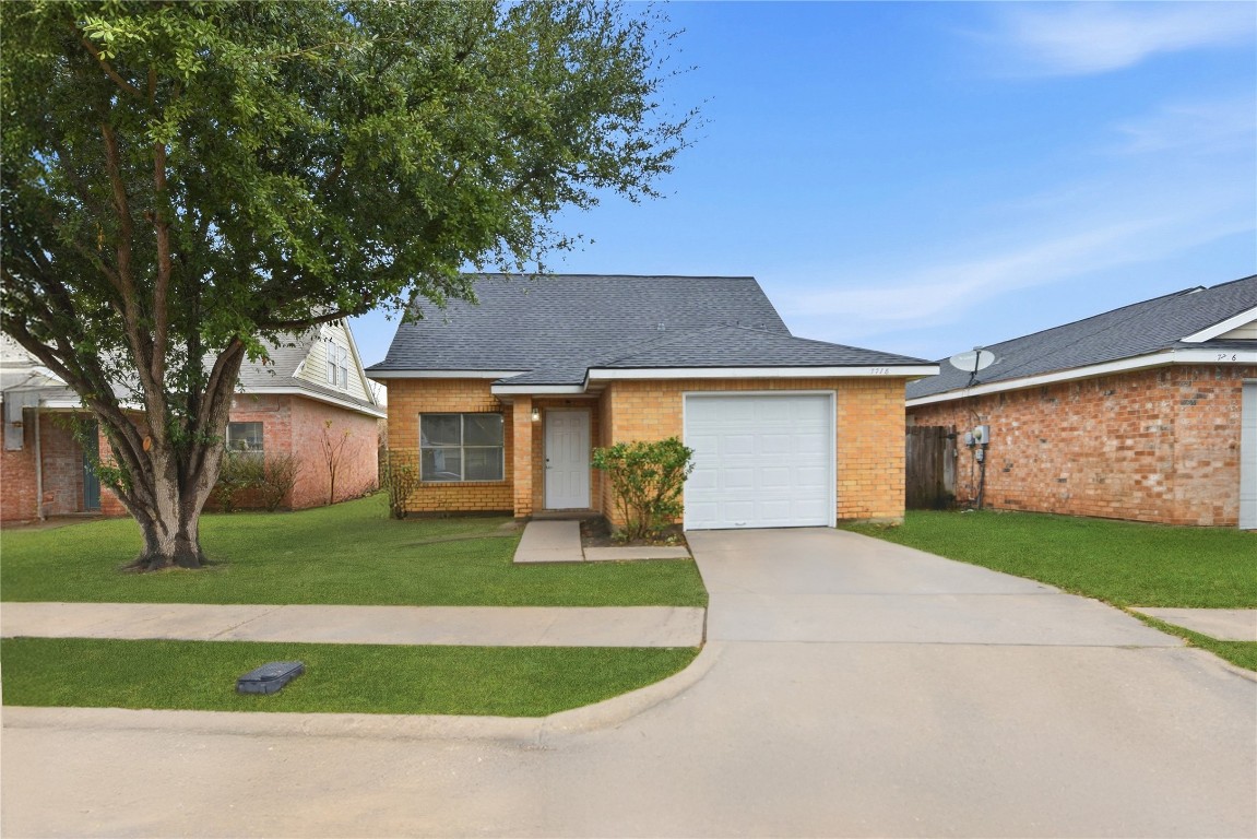 7718 Sign Street Houston, TX 77489 - Photo 1 of 24 a front view of a house with garden