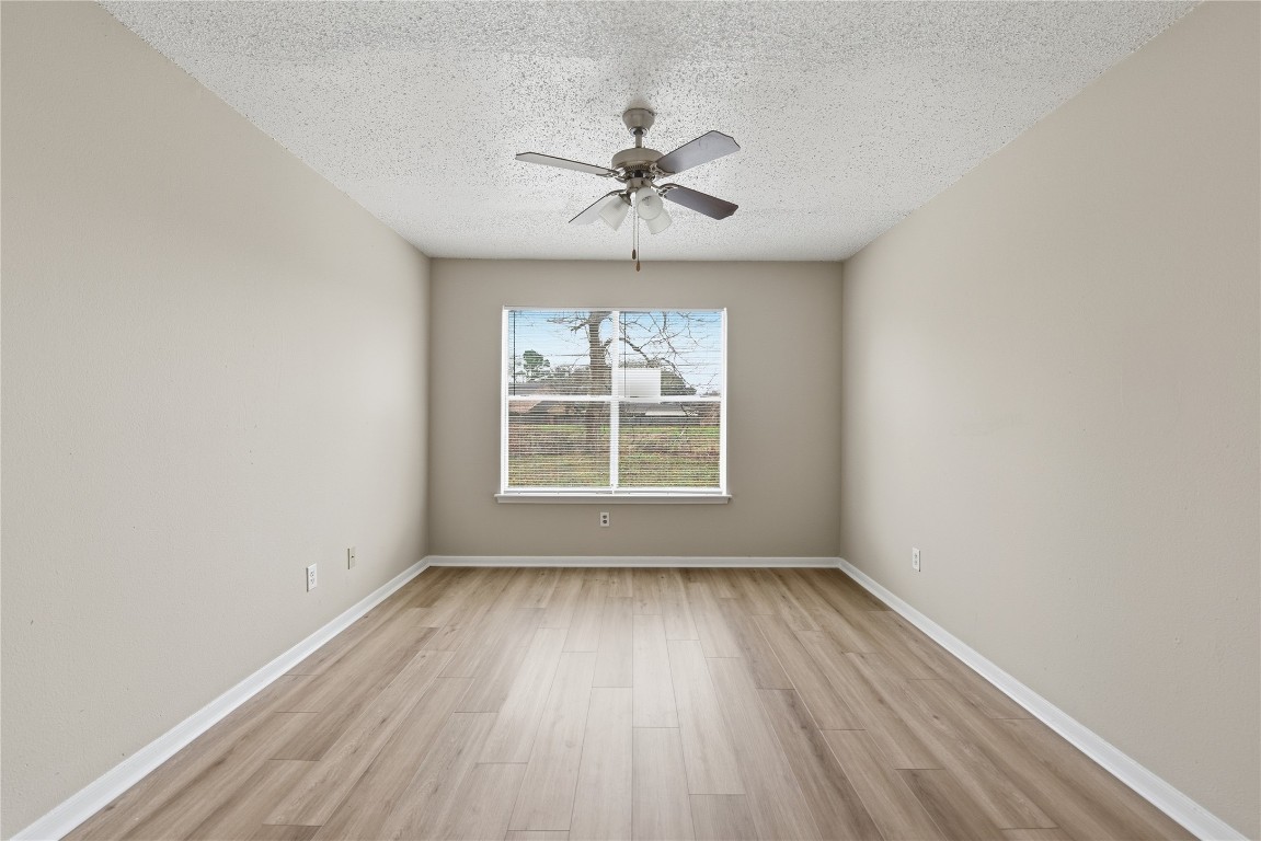 7718 Sign Street Houston, TX 77489 - Photo 11 of 24 wooden floor in an empty room with a window