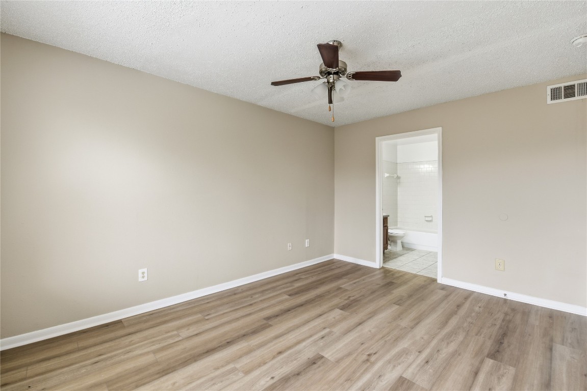 7718 Sign Street Houston, TX 77489 - Photo 13 of 24 a view of a big room with wooden floor and windows in a room