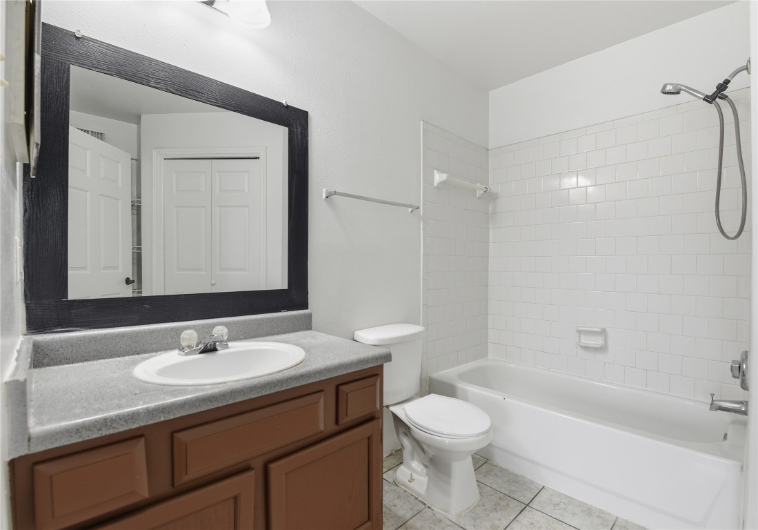 7718 Sign Street Houston, TX 77489 - Photo 14 of 24 a bathroom with a granite countertop sink toilet a shower and a mirror