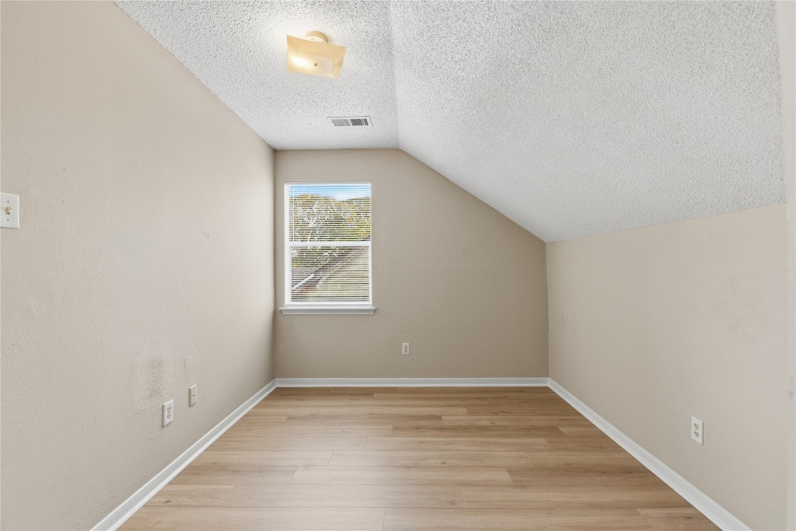 7718 Sign Street Houston, TX 77489 - Photo 18 of 24 a view of a room that has wooden floor and brick walls