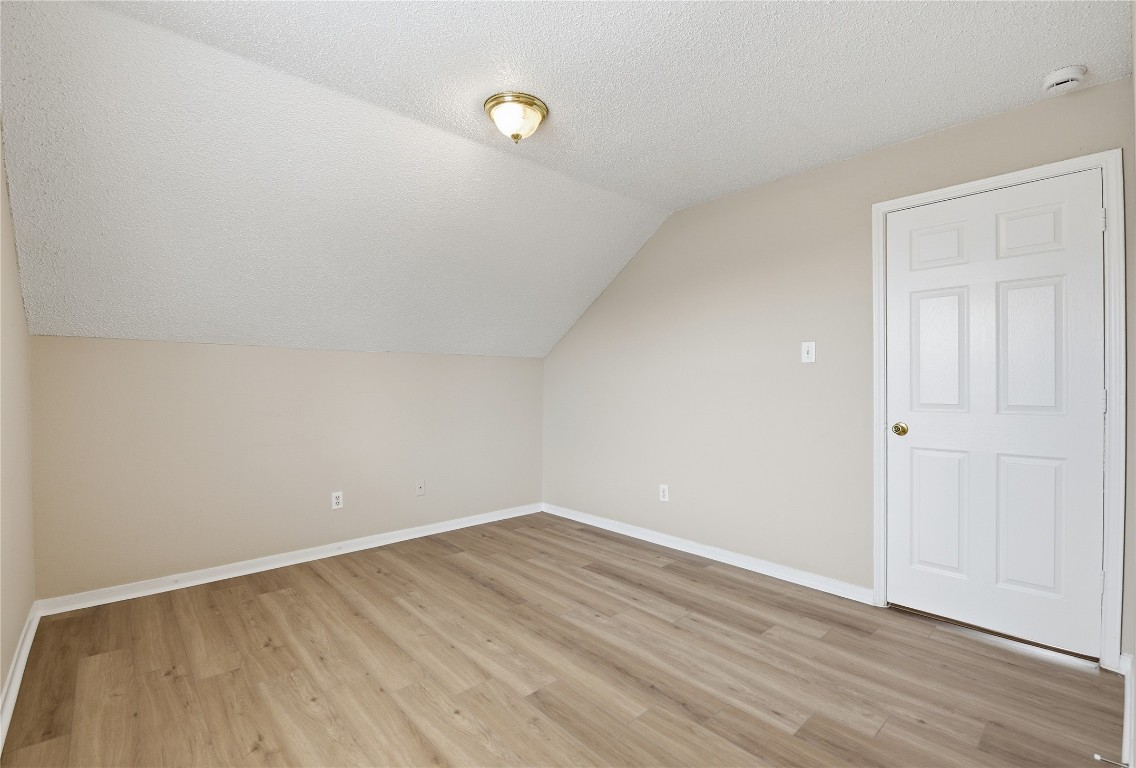 7718 Sign Street Houston, TX 77489 - Photo 19 of 24 a view of an empty room with wooden floor
