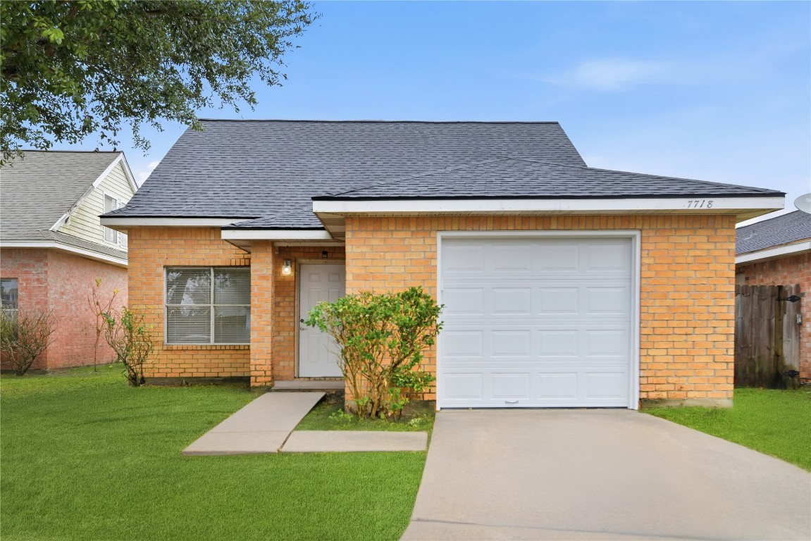 7718 Sign Street Houston, TX 77489 - Photo 2 of 24 a front view of a house with a yard