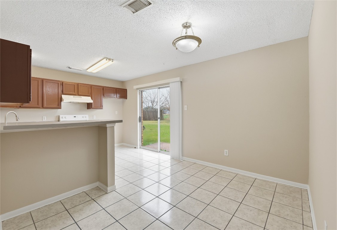 7718 Sign Street Houston, TX 77489 - Photo 10 of 24 a kitchen with granite countertop a sink cabinets and appliances