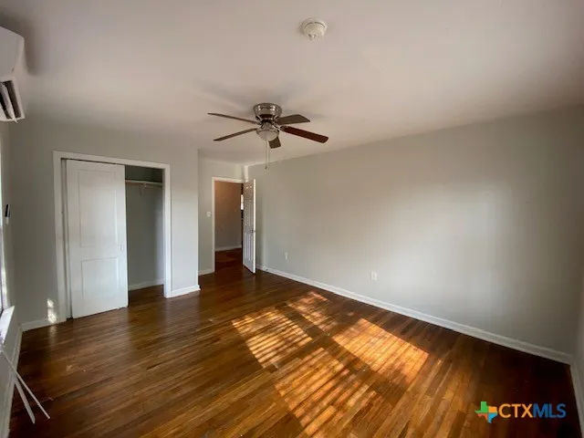 a view of an empty room and wooden floor