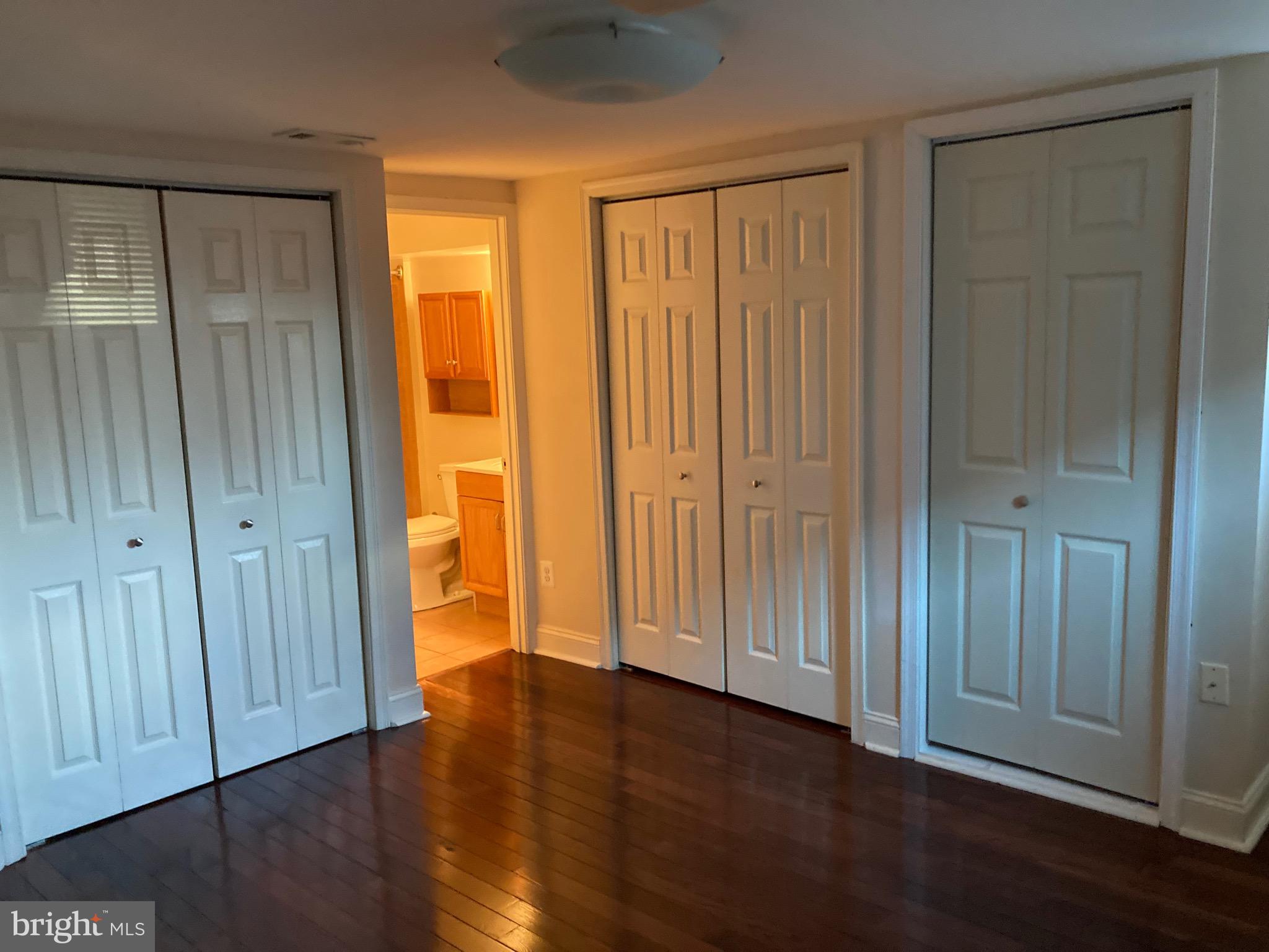 2225 Brookfield Avenue Baltimore, MD 21217 - Photo 11 of 28 an empty room with wooden floor and closet area
