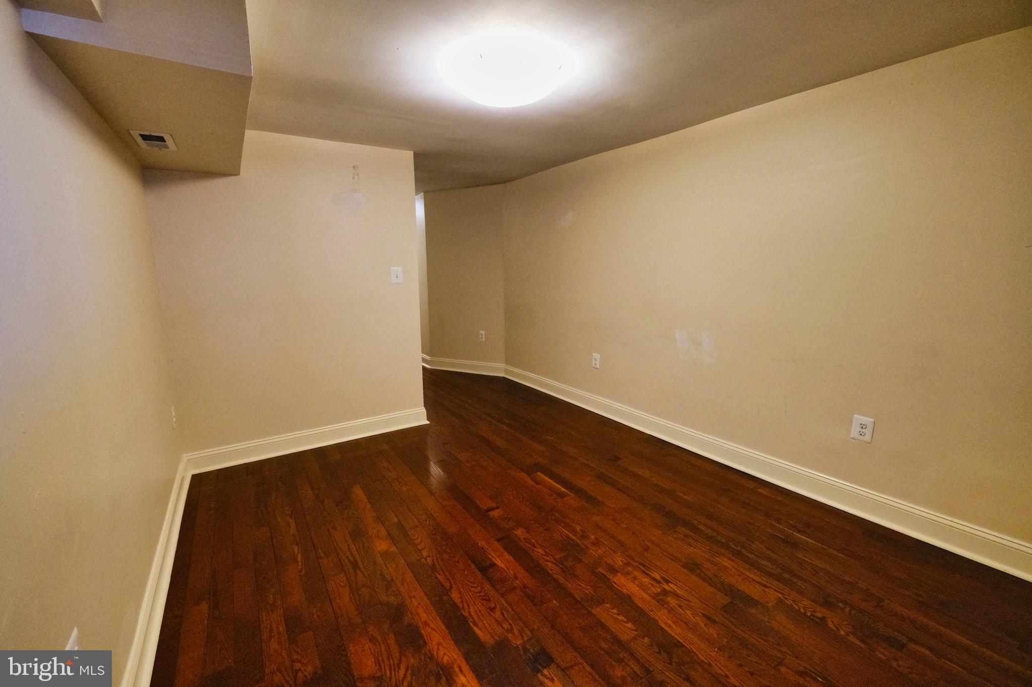 2225 Brookfield Avenue Baltimore, MD 21217 - Photo 13 of 28 a view of an empty room with wooden floor