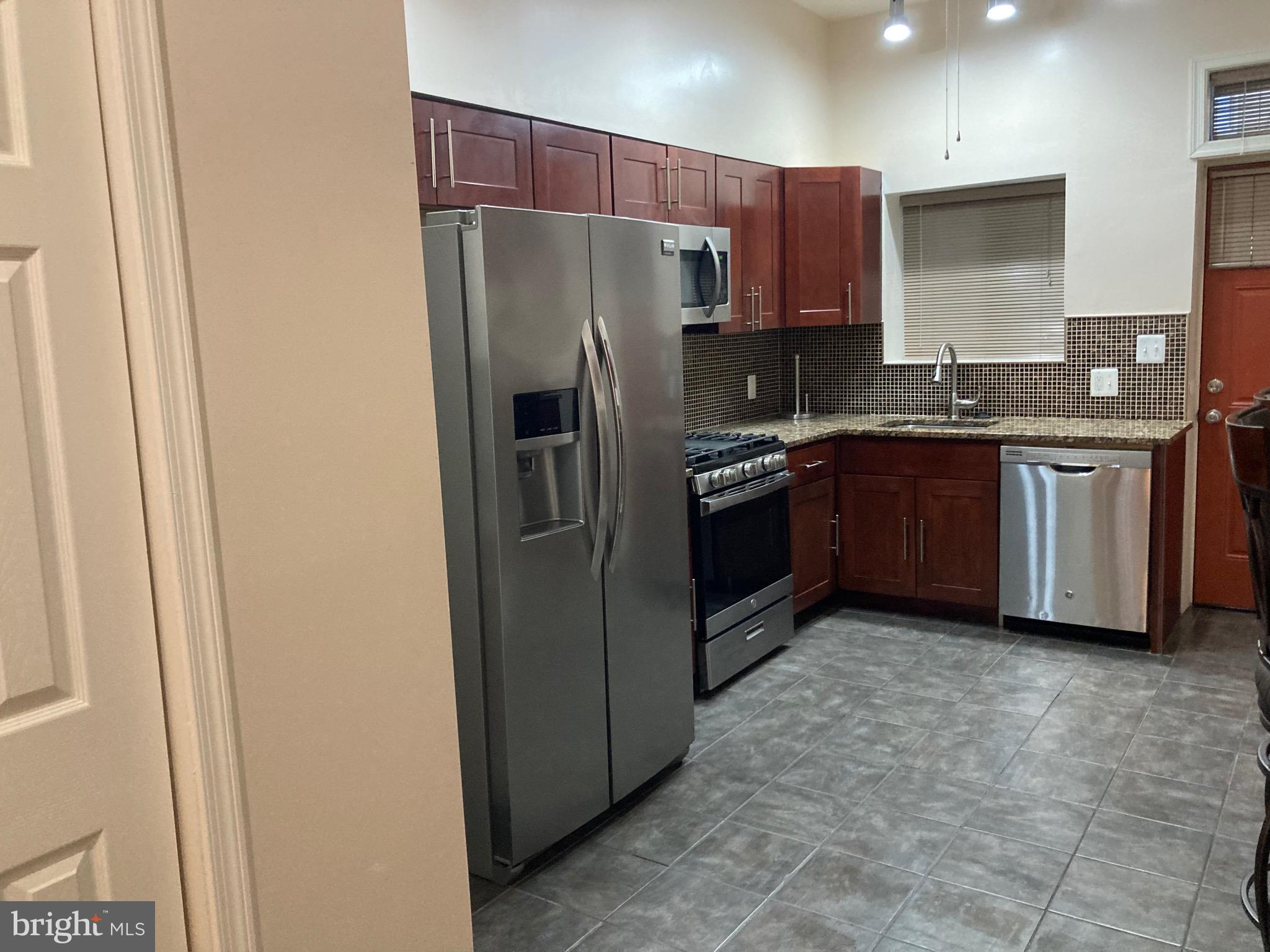 2225 Brookfield Avenue Baltimore, MD 21217 - Photo 21 of 28 a kitchen with stainless steel appliances granite countertop a refrigerator and a stove