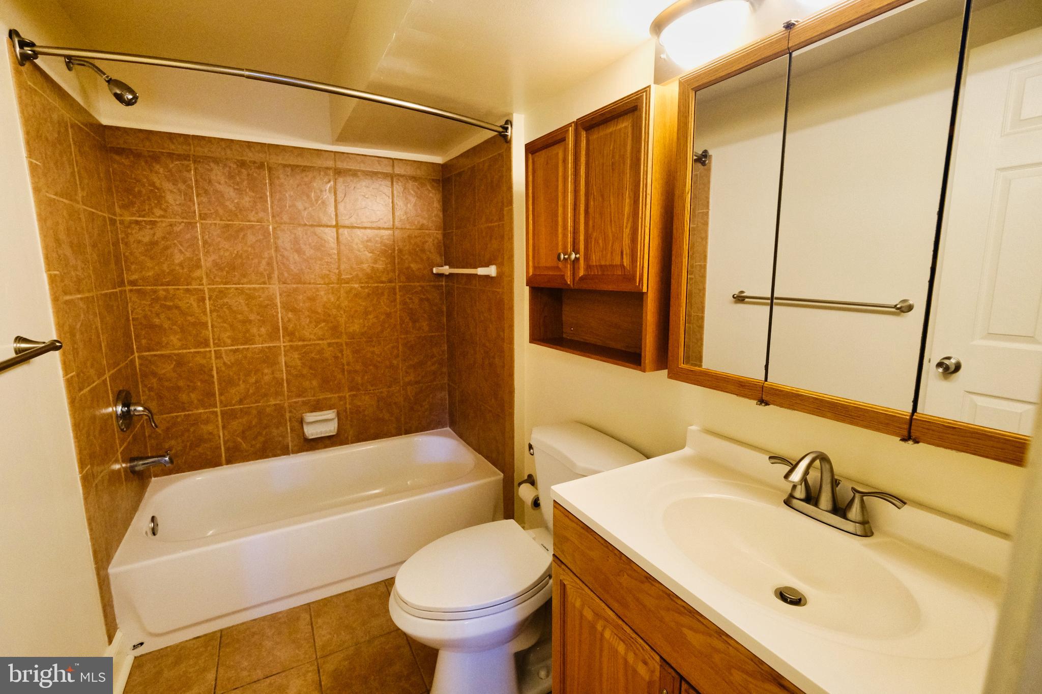 2225 Brookfield Avenue Baltimore, MD 21217 - Photo 9 of 28 a bathroom with a sink mirror toilet and bathtub