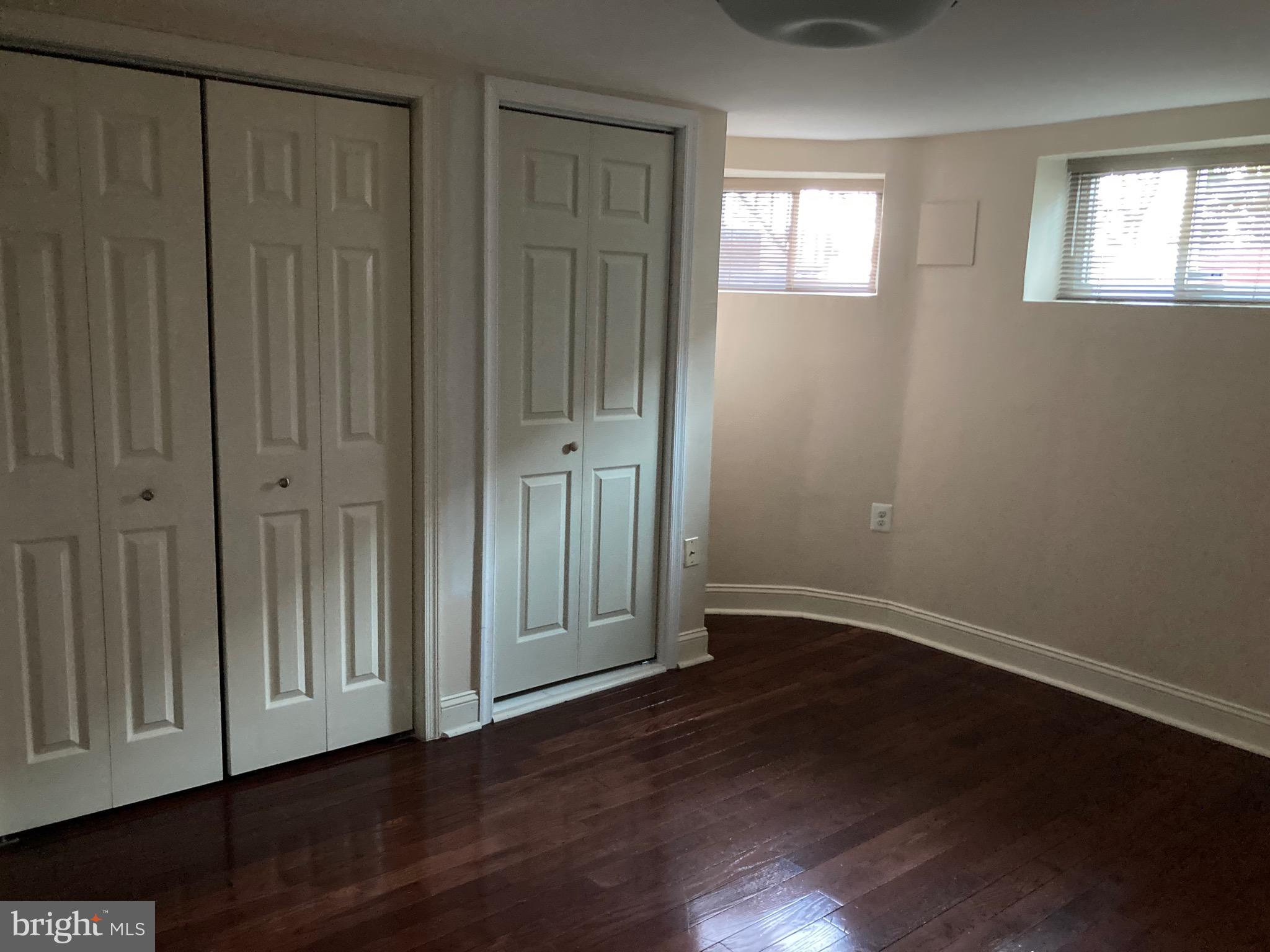 2225 Brookfield Avenue Baltimore, MD 21217 - Photo 10 of 28 an empty room with wooden floor closet and windows
