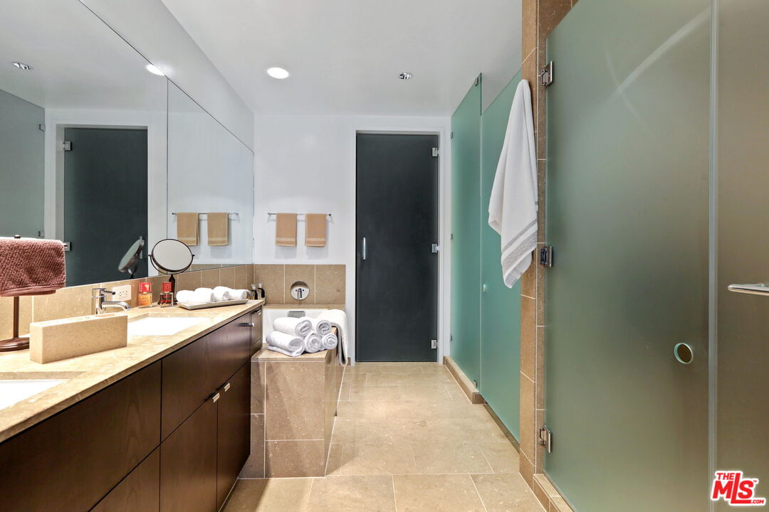 6250 Hollywood Boulevard, Unit 5J Los Angeles, CA 90028 - Photo 19 of 40 a bathroom with a double vanity sink and a mirror