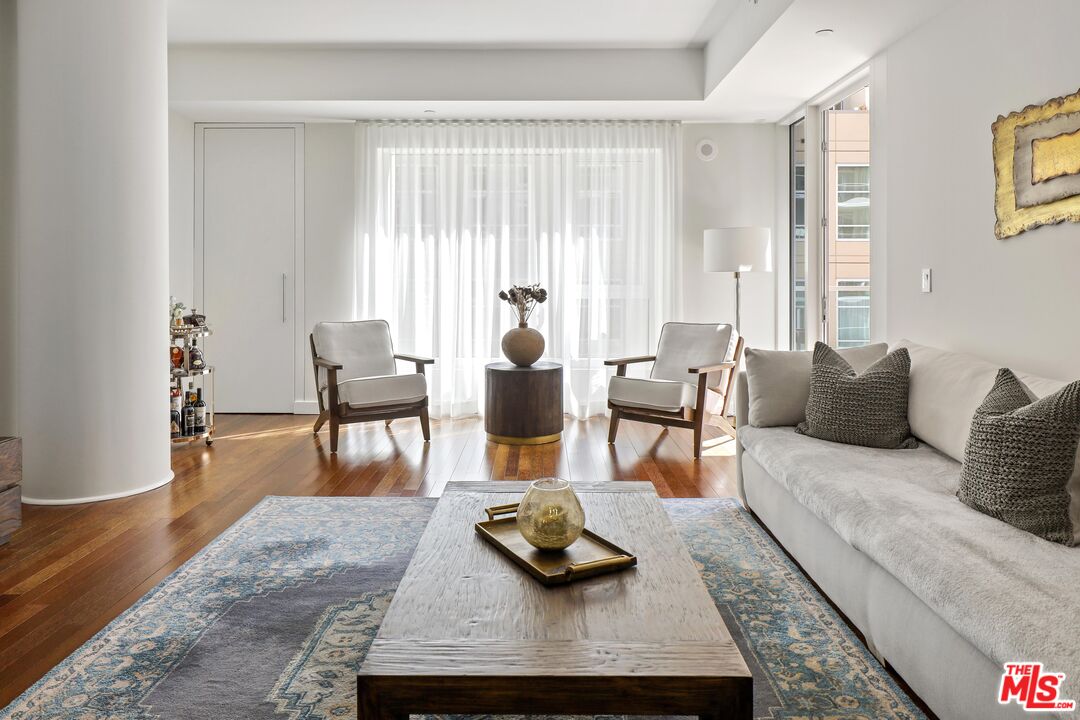 6250 Hollywood Boulevard, Unit 5J Los Angeles, CA 90028 - Photo 2 of 40 a living room with furniture and a wooden floor