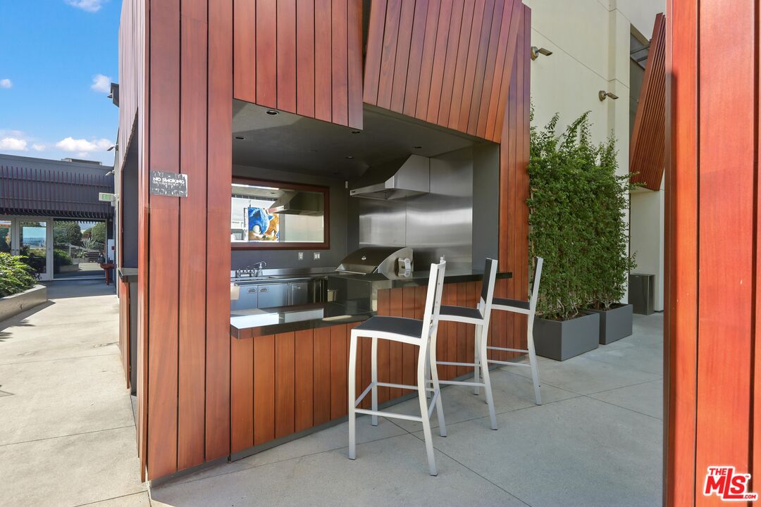 6250 Hollywood Boulevard, Unit 5J Los Angeles, CA 90028 - Photo 24 of 40 a kitchen view with a table and chairs in front of it