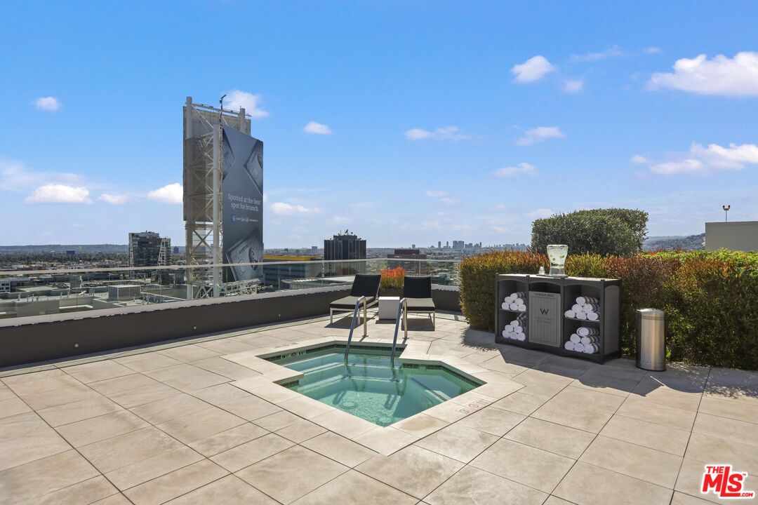 6250 Hollywood Boulevard, Unit 5J Los Angeles, CA 90028 - Photo 30 of 40 a roof deck with table and chairs and potted plants