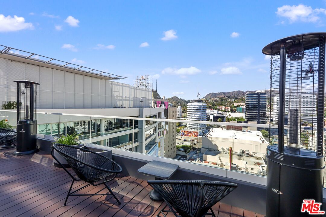 6250 Hollywood Boulevard, Unit 5J Los Angeles, CA 90028 - Photo 35 of 40 a view of a chairs and table in patio with a barbeque grill