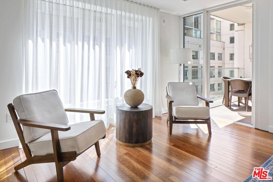 6250 Hollywood Boulevard, Unit 5J Los Angeles, CA 90028 - Photo 4 of 40 a dining room with furniture and wooden floor
