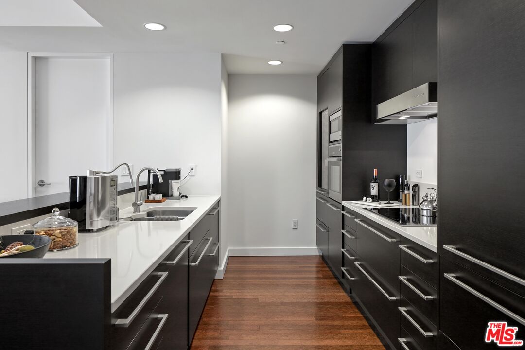 6250 Hollywood Boulevard, Unit 5J Los Angeles, CA 90028 - Photo 7 of 40 a kitchen with stainless steel appliances granite countertop a sink and stove