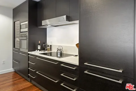 a kitchen with a sink appliances and a window