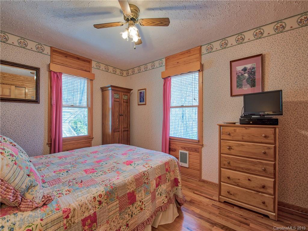 464 Bent Tree Road Maggie Valley, NC 28751 - Photo 14 of 38 a bedroom with a bed and wooden floor