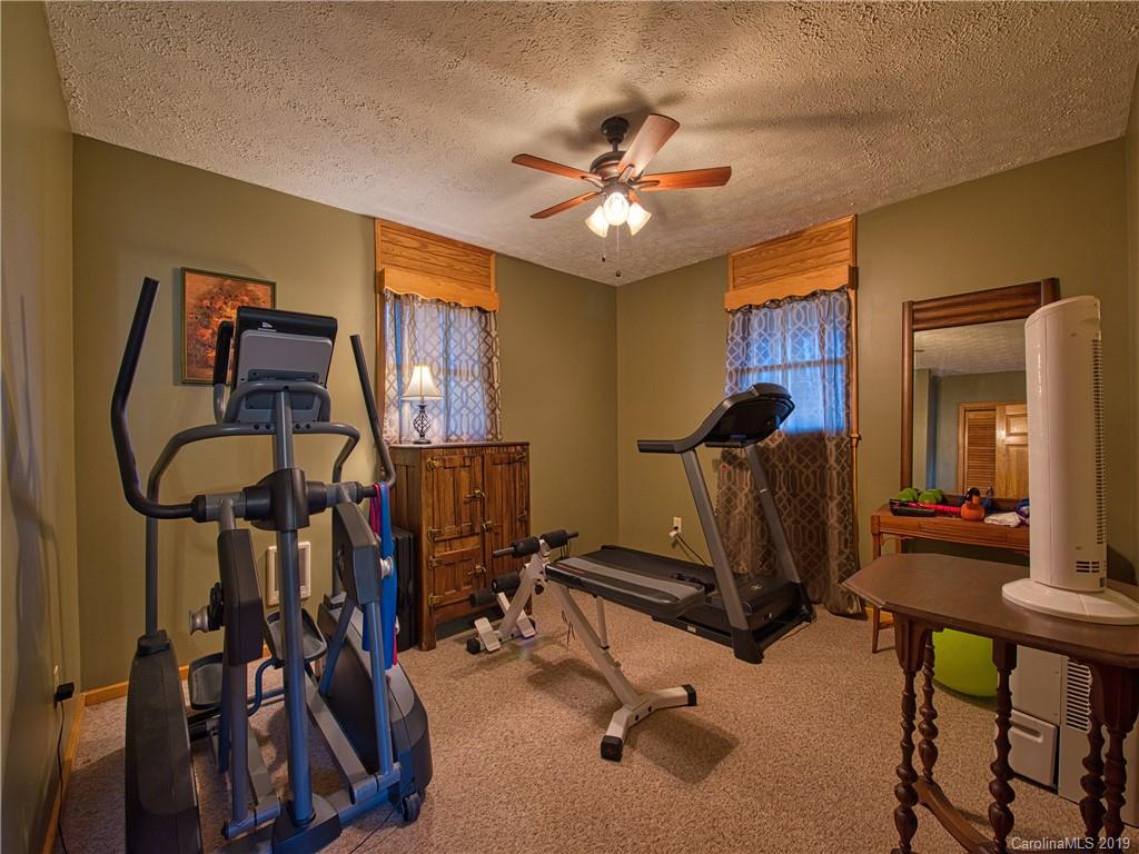 464 Bent Tree Road Maggie Valley, NC 28751 - Photo 20 of 38 a room with gym equipment and windows