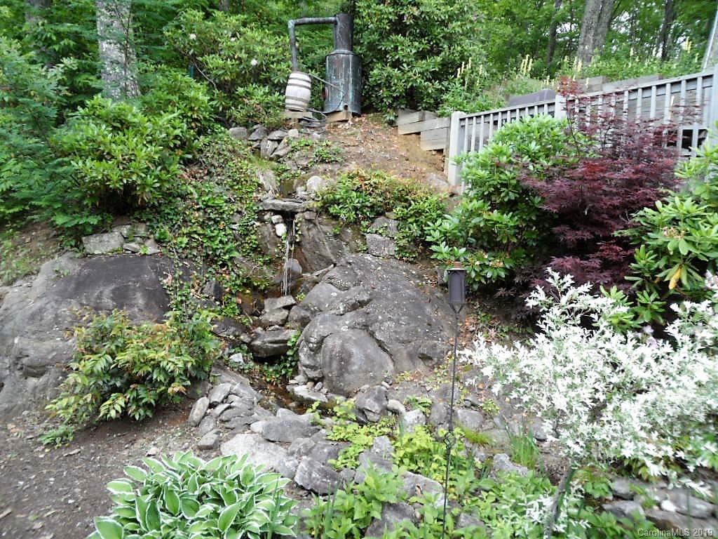 464 Bent Tree Road Maggie Valley, NC 28751 - Photo 28 of 38 a view of a garden with plants and flowers