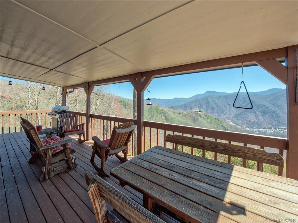 464 Bent Tree Road Maggie Valley, NC 28751 - Photo 33 of 38 a view of a balcony with chairs and wooden floor