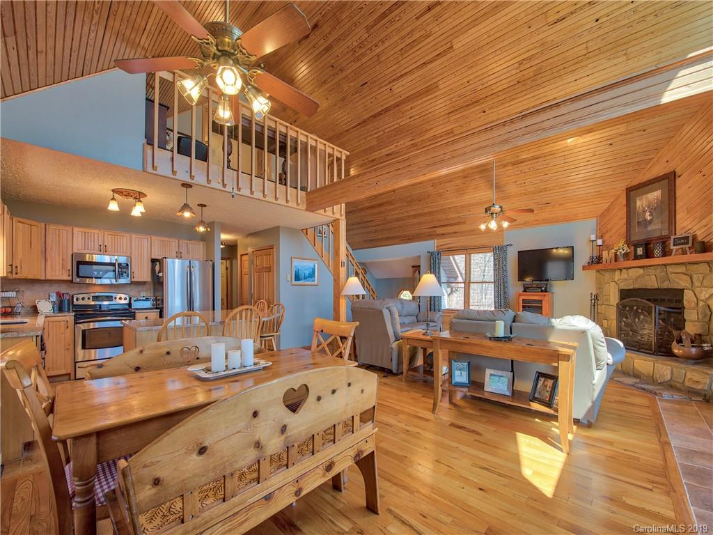 464 Bent Tree Road Maggie Valley, NC 28751 - Photo 6 of 38 a view of a dining room with furniture a chandelier and wooden floor