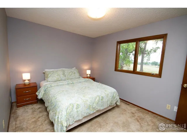 a bedroom with a bed and a lamp