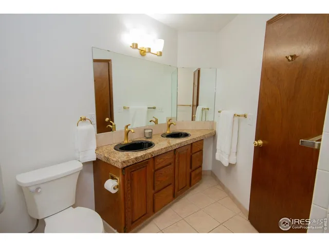 a bathroom with a sink mirror vanity and toilet