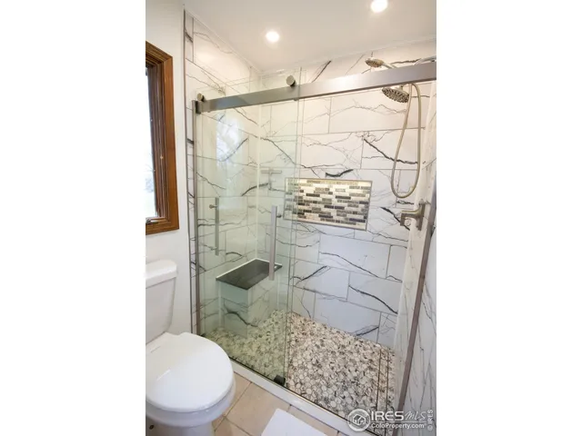 a bathroom with a toilet and shower