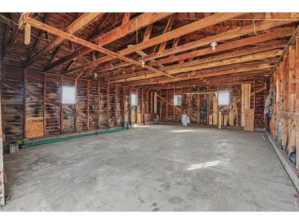 a view of an empty room with a fireplace and a window