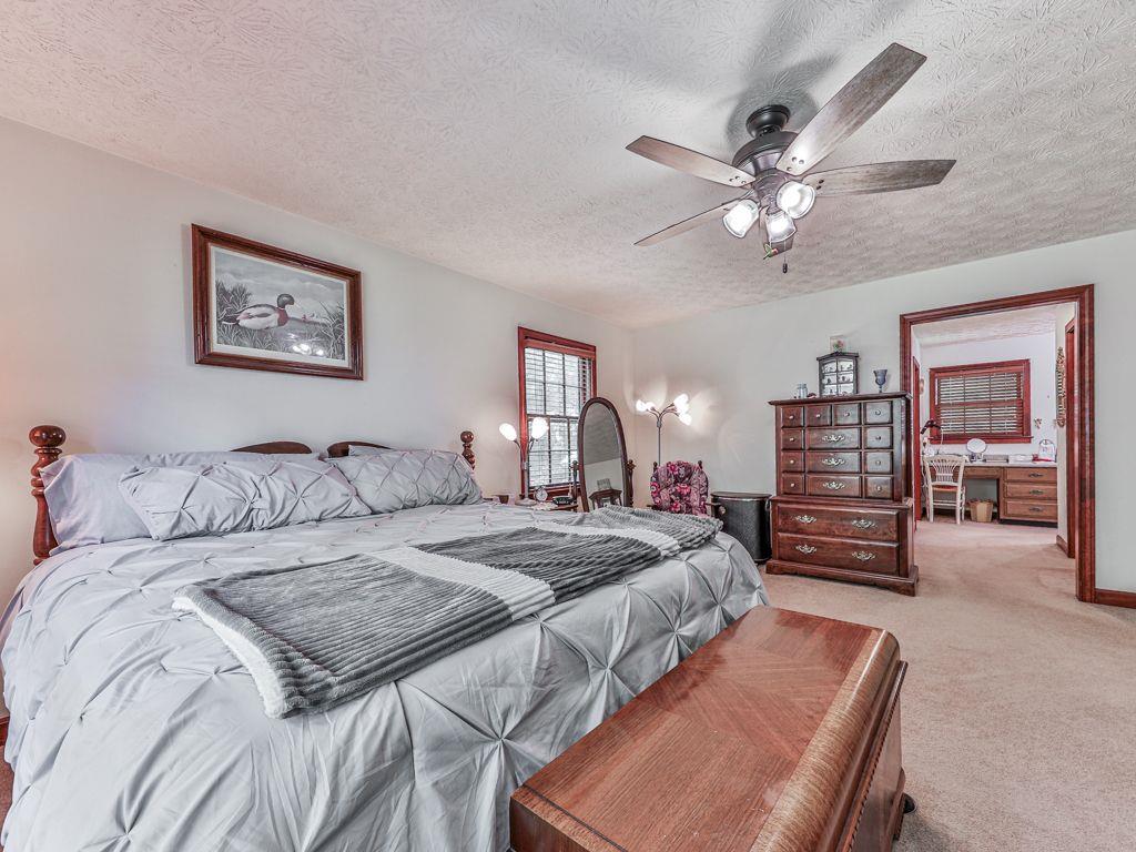 2760 Hembree Road Northeast Marietta, GA 30062 - Photo 19 of 65 a bed room with a bed and a chandelier