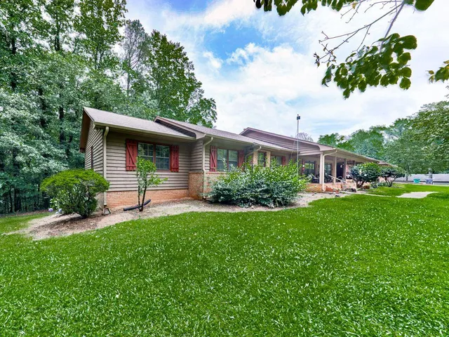 a front view of house with a garden