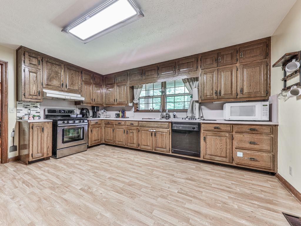 2760 Hembree Road Northeast Marietta, GA 30062 - Photo 39 of 65 a kitchen with stainless steel appliances granite countertop a stove top oven sink and cabinets