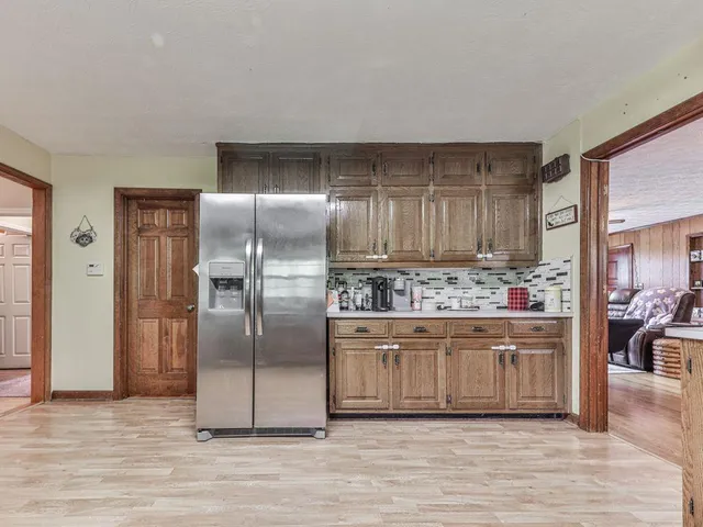 a bathroom with a granite countertop sink a mirror and a shower
