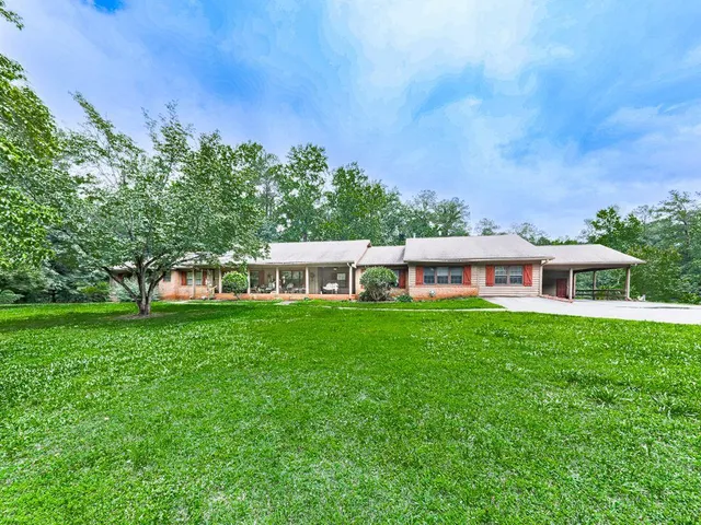 a view of a house with backyard and garden