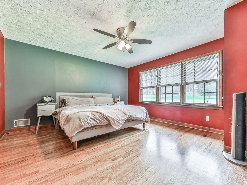 2760 Hembree Road Northeast Marietta, GA 30062 - Photo 43 of 65 a spacious bedroom with a bed and a chandelier